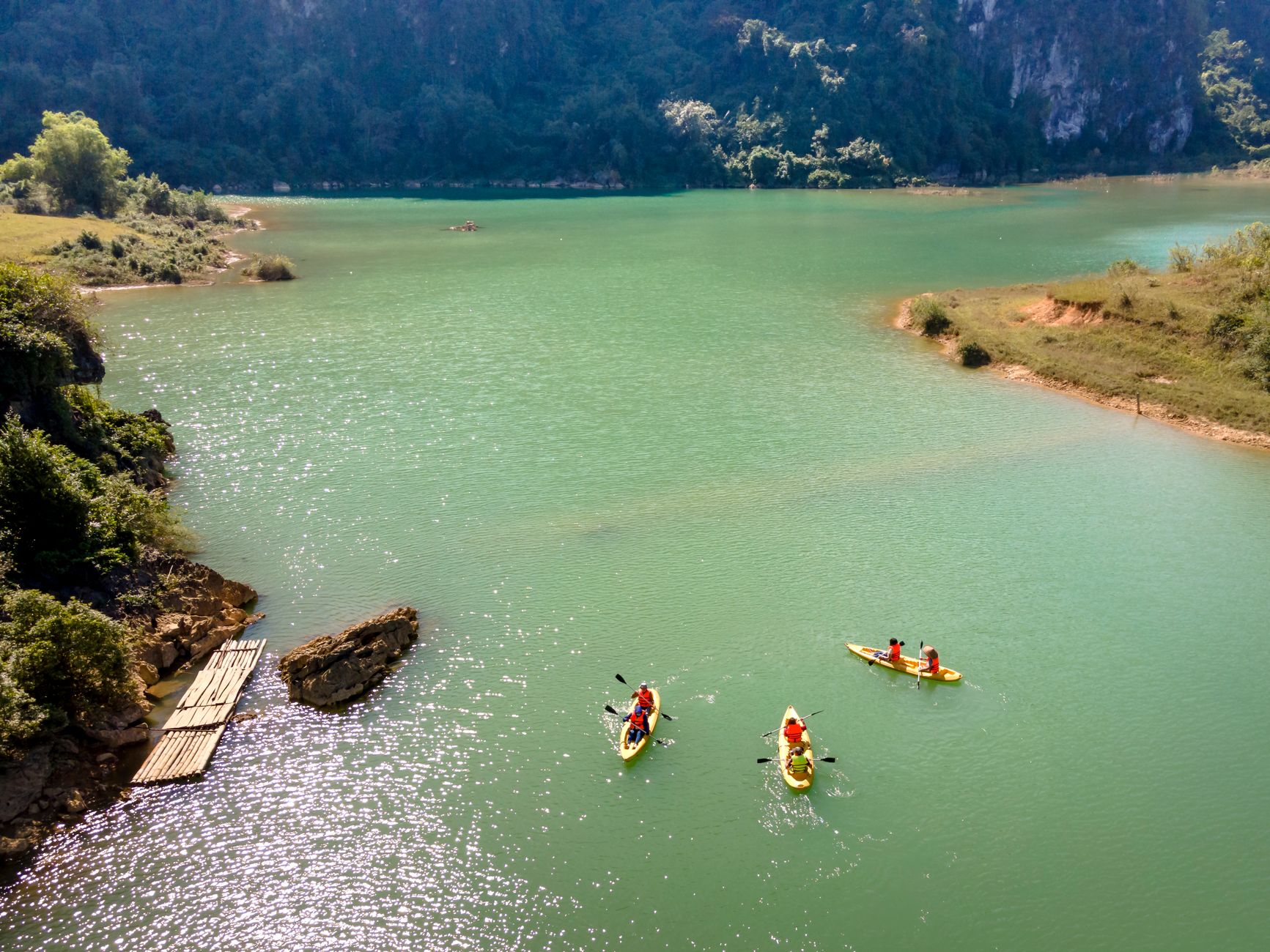 children kayaking lake
