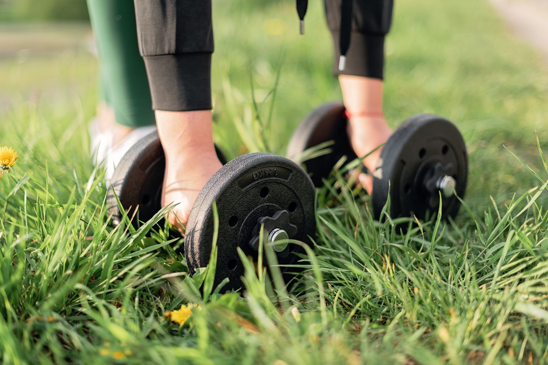 woman lifting dumbbell park