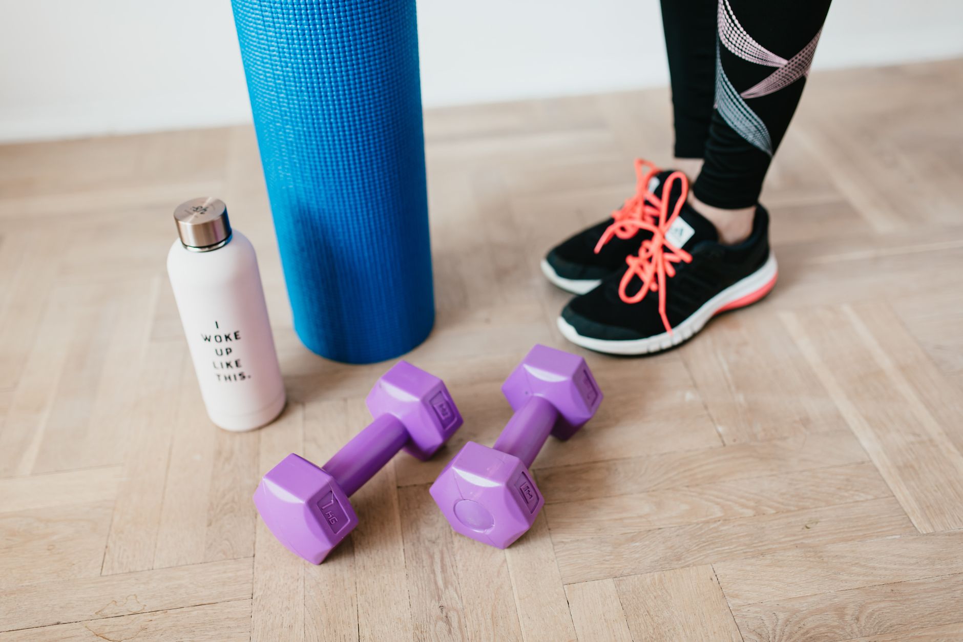 yoga mat dumbbells wooden floor