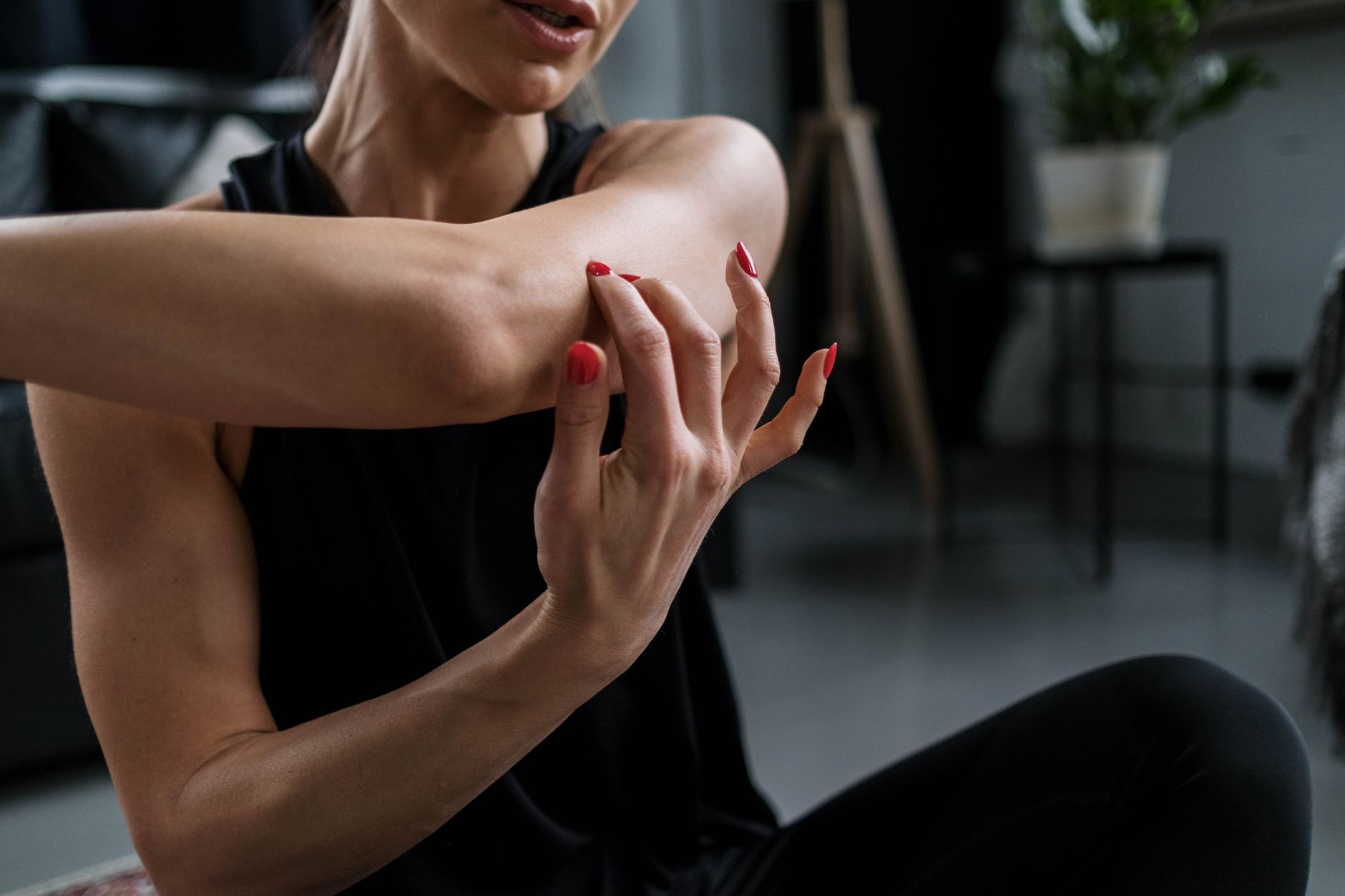 woman stretching arms doorway