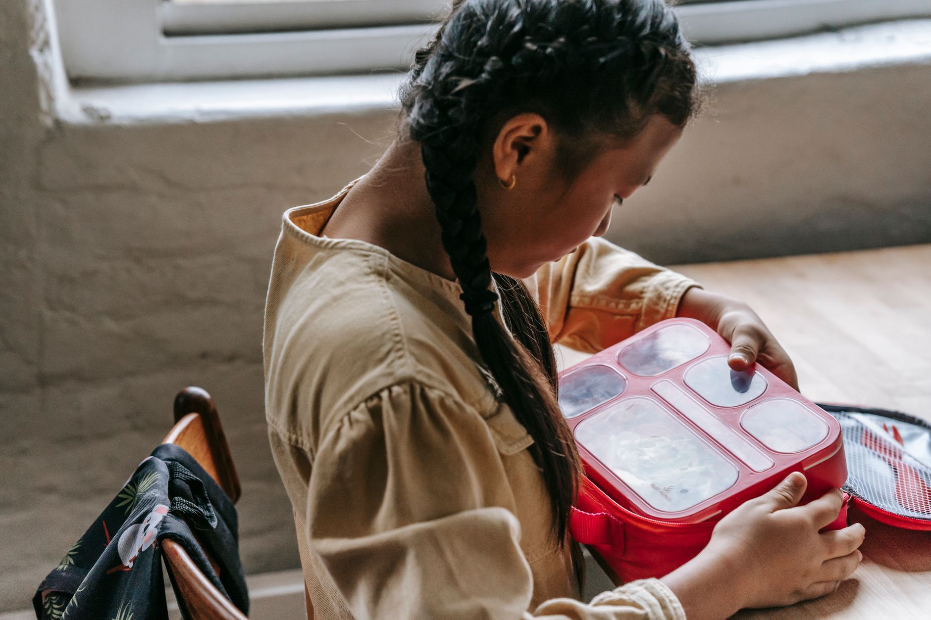 child hands lunch box opening