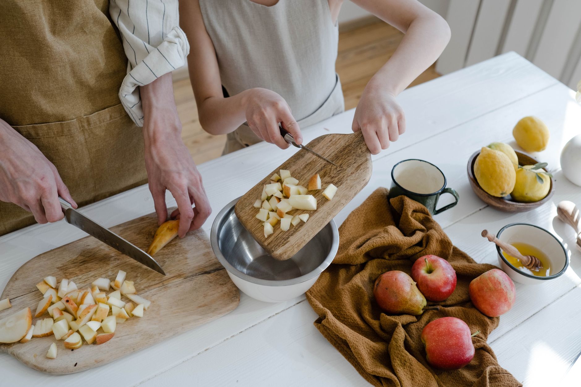 child reaching apple fruit bowl