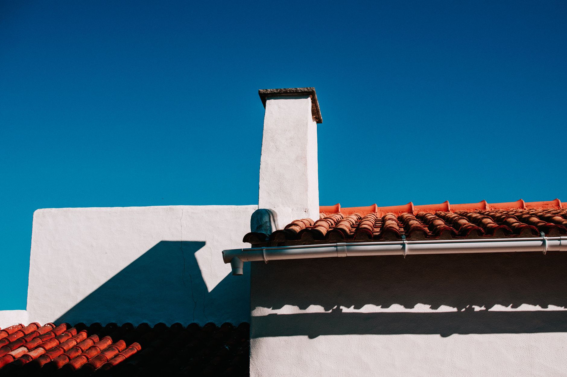 whitewashed portugal building blue sky